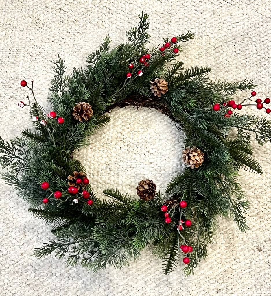 Image of wreath before refresh and after refresh with updated red berries.